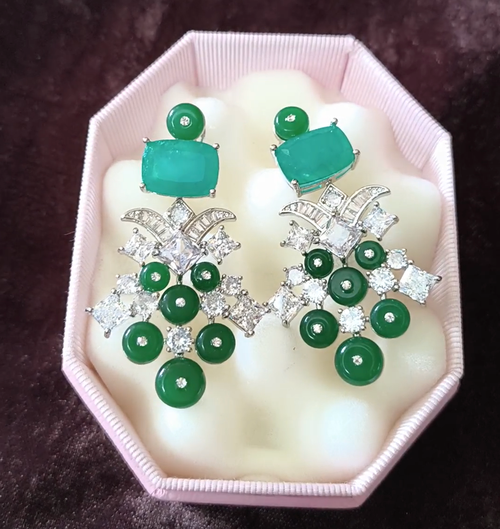Pair of earrings with green gemstones and silver accents