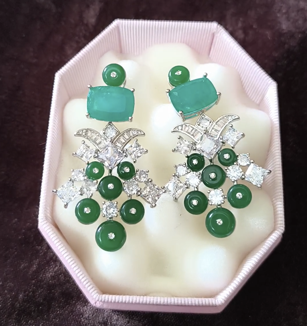 Pair of earrings with green gemstones and silver accents 