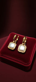 Gold earrings with square gemstones 