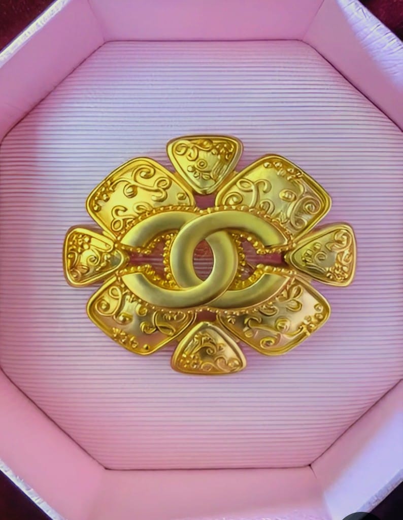 Gold Chanel logo brooch